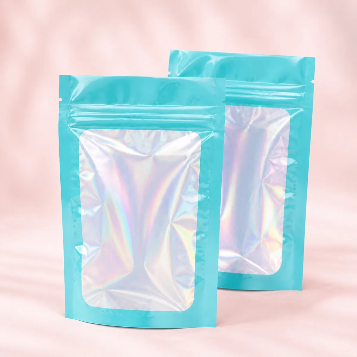 Empty aqua holographic zipper bags in two sizes.